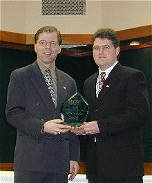 Mike Schafer receives the COTY Award from ECAC Associate Commissioner Steve Hagwell