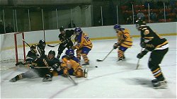 The Soaring Eagles pounce on a loose puck.