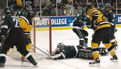 Jeff Lerg makes a diving stop on Chad Rau's wraparound attempt. Photo by: Candace Horgan