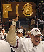 Krys Kolanos holds aloft the NCAA championship trophy after scoring the game-winner Saturday. (Photo by Jayson Moy)