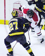 Michigan senior defenseman Dave Huntzicker (27) helped keep previously-hot Tyler Arnason and the Huskies at bay (photo by Christopher Brian Dudek).