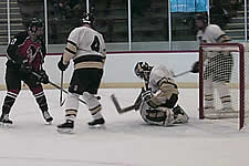 Superior's Nate Ziemski makes a bread-basket save during a River Falls first-period power play. (Photos by Ed Trefzger)