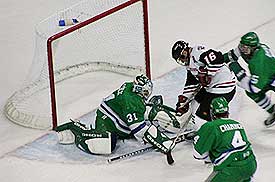 Mercyhurst goaltender Matt Cifelli stops Northeastern's Chris Lynch (16) from point blank in the first period.