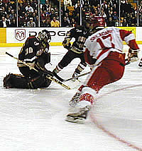 BC goalie Matti Kaltiainen makes a stop in the Eagles' 5-3 loss in Monday's Beanpot opener, while Frantisek Skladany (17) looks for a rebound.