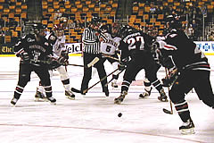 NU captain Jim Fahey (44, right) goes to the puck in Monday's semifinal (photo: Irwin Schreiman)