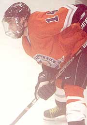 Hobart's Kevin Coakley battles the fog as he lines up for a faceoff. (photo by Thomas E. Safran)