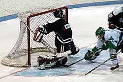 Mercyhurst's Tom McMonagle tucks the gamewinner past UConn goalie Artie Imbriano. (photo by Jim Connelly)