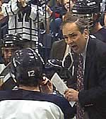 Middlebury coach Bill Beaney confers with his squad during his time out with 2:49 on the clock, just before pulling goaltender Carlsson.