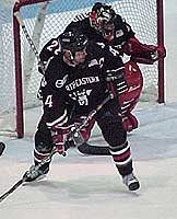 Northeastern Goalie Jason Braun and captain Jim Fahey (4) protect the net in the third period of the Huskies' 3-1 win over Providence on Friday night. (photo courtesy Northeastern sports information)