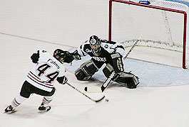 Northeastern's Jim Fahey makes a move on Providence goaltender Nolan Schaeffer to give the Huskies a 2-0 lead.