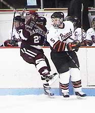 Princeton's Jesse Masear puts a hit on Harvard's Aaron Kim. (photos by Adam Wodon)