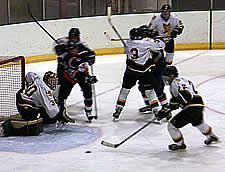 Brockport's Paul Stasko clears the puck from in front of his own net.