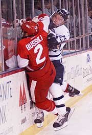 UNH's Patrick Foley lays a big hit on BU's Mike Bussoli. (photos: Josh Gibney)