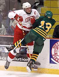 Cornell defenseman Doug Murray lays a big hit on Scott Mifsud.