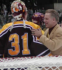 Norwich coach Mike McShane congratulates rookie goaltender Mike Boudreau. (Photos: Chris Lerch)