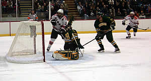 Oswego's Tyson Gajda makes one of his 27 saves, on a point blank Mike Bournazakis shot. (Photos by Russell Jaslow)