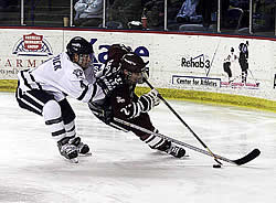 Chris Capraro goes wide around UNH defenseman Mike Lubesnick.  Capraro assisted on the Minutemen's only goal.