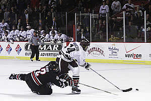 Greg Mauldin is hauled down on a breakaway late in the game by Northeastern defenseman Jon Awe.