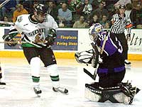 Maverick goalie Jason Jenson covers up as Sioux forward Brandon Bochenski looks for rebound. Bochenski had a goal and two assists in the game. (photo: Patrick C. Miller)