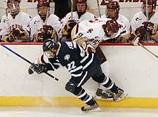 UNH's Kevin Truelson hip checks Pat Eaves in front of the BC bench. (photos: Josh Gibney)