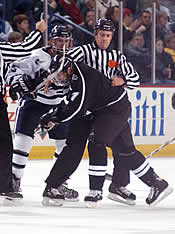 Officials separate UNH's Jim Abbott and Providence's Shawn Weiman after a scuffle.