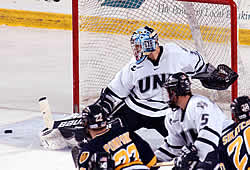 New Hampshire's Mike Ayers kicks aside the puck for one of his 22 saves.