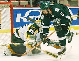 Wildcats goalie Tuomas Tarkki stops Michigan State's Tom Goebel for one of his 35 saves. (photo: Christopher Brian Dudek)