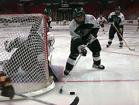 Dartmouth's Kate Lane protects the side of the net as Melissa Coulombe steers the puck away.