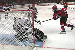 Harvard's Ali Boe makes a spectacular save on a point-blank shot from SLU's Rebecca Russell on the power play (Photo: Russell Jaslow)