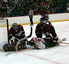 Ryan Venturelli steers the puck aside as Jason Brothers pins Tristan Fairbarn.