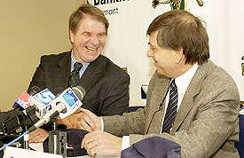 UVM president Dan Fogel (l.) accepts a Hockey East cap from league commissioner Joe Bertagna as the two sides announced their union, beginning in 2005. (photo: William DiLillo, UVM)