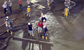 Workers pour the concrete onto the new Agganis Arena floor.