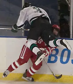 Matt Jones of UND makes a hit on BU's Peter MacArthur.