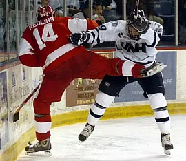 UNH's Matt Fornataro (r.) checks BU's Jekabs Redlihs during the third period Saturday (photo: Josh Gibney).