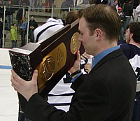 Panther assistant Chris LaPerle admires the D-III trophy.