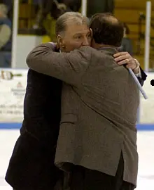 MC coach Chris Serino embraces his friend, UNH coach Dick Umile, after the game.