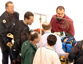 Robbie Bina is taken off the ice after his neck injury at the WCHA Final Five (photo: John Dahl / SiouxSports.com).
