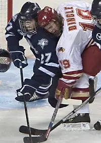 DU's Ryan Dingle and UNH's Daniel Winnik battle for position Sunday.