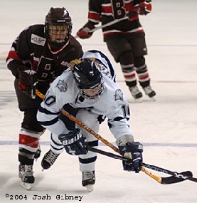 Brown's Katie Guay hooks UNH's Jenni Hitchock (photo: Josh Gibney)