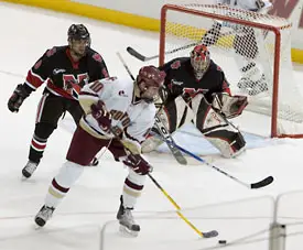 BC's Brian Boyle (front) scores past Jacques Perrault (l.) and Adam Geragosian.