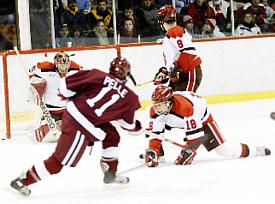 Harvard's Jon Pelle shoots on SLU netminder Justin Pesony earlier this season.  Pesony is the reigning ECACHL goaltender of the week (photo: Lowell Chow).