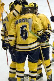 T.J. Hensick and Brandon Kaleniecki celebrate with Matt Hunwick after Hunwick's first goal tied the game at 1 (photo: Ray Bartnikowski).