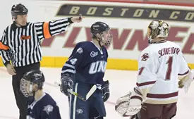 Referee Scott Hansen signals a UNH goal, while Josh Ciocco takes exception to BC netminder Cory Schneider's protest.