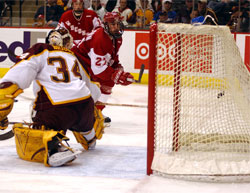 Ross Carlson (27) scores UW's third goal against Kellen Briggs (photo: Jason Waldowski).