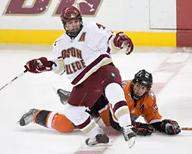 Joe Rooney eyes the puck after colliding with Brandon Svendsen at center ice (photo: Melissa Wade). 