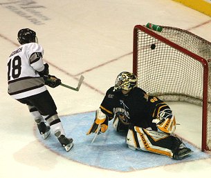 Peter Bogdnich scores the shootout winner over Bud Fisher. (photo:  Jack McDonald/Quinnipiac University)