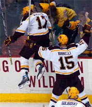 Blake Wheeler leaps against the boards in celebration, with captain Mike Vannelli and Alex Goligoski right behind him (photo: Jason Waldowski).