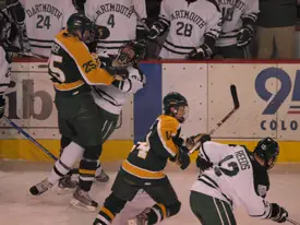 Andrew Sarauer puts a big hit on Dartmouth's Peter Boldt. Photo: Candace Horgan