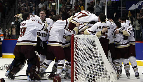 Boston College freshman Brian Gibbons (17) leaps onto the top of the pile as the Eagles celebrate their championship (photo: Jim Rosvold.)