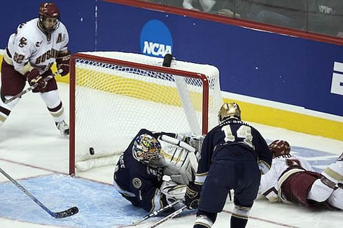 Nathan Gerbe (diving, r.) pokes home the game-winning goal in the second period (photo: Jim Rosvold.)